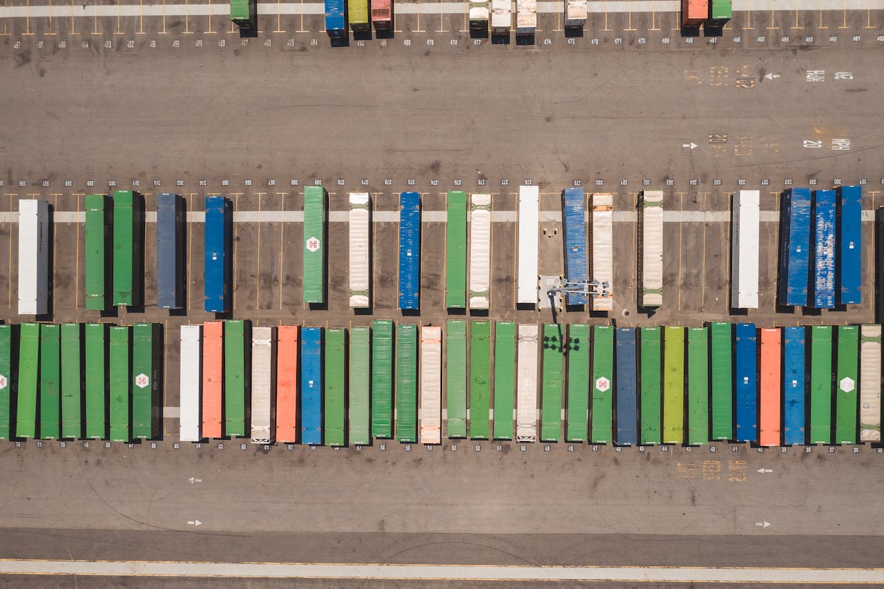 heros-img Top view of neatly arranged cargo containers in a shipping port, highlighting logistics and global trade.